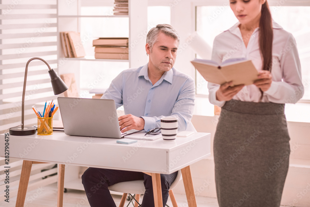 Man indecently looking at his colleague while working Man indecently looking at his colleague while working