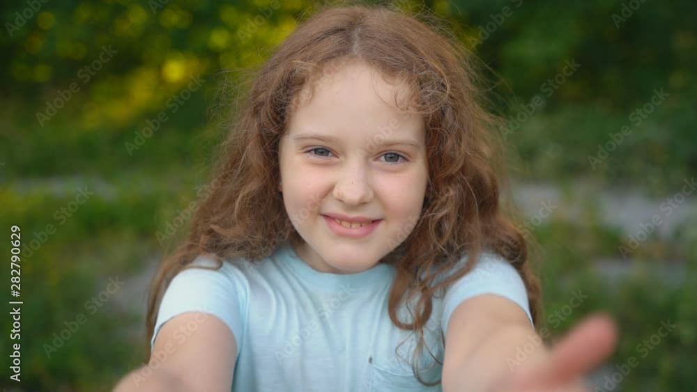 Cute curly girl showing thumbs up. Cute curly girl showing thumbs up.