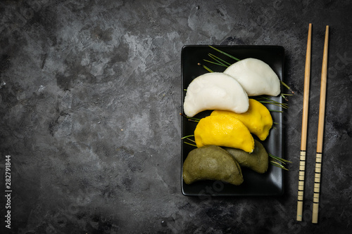 Chuseon day concept, korean thanksgiving day - songpyeon rice cakes on rustic background, top view photo