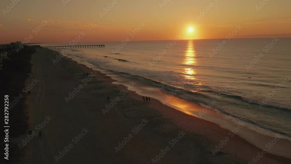Drone Shot of Wrightsville Beach sunrise with surfers and waves Drone Shot of Wrightsville Beach sunrise with surfers and waves