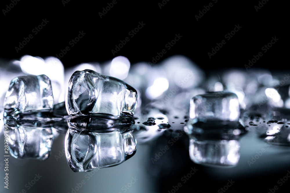 pile of different ice cubes on reflection table on black background pile of different ice cubes on reflection table on black background