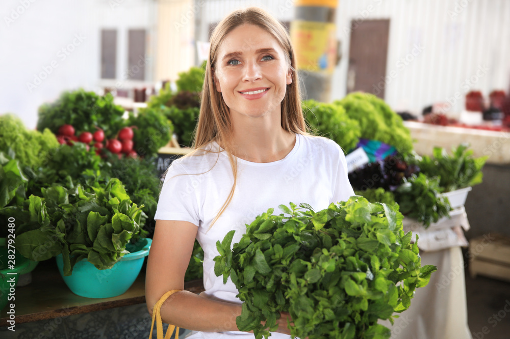 Woman with fresh mint at market Woman with fresh mint at market