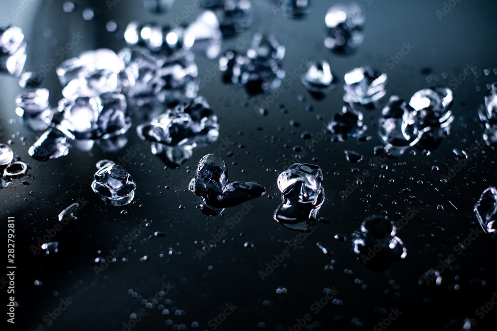 pile of different ice cubes on reflection table on black background pile of different ice cubes on reflection table on black background