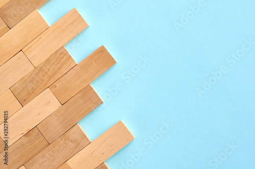 Brown wooden blocks idea on blue background composition.