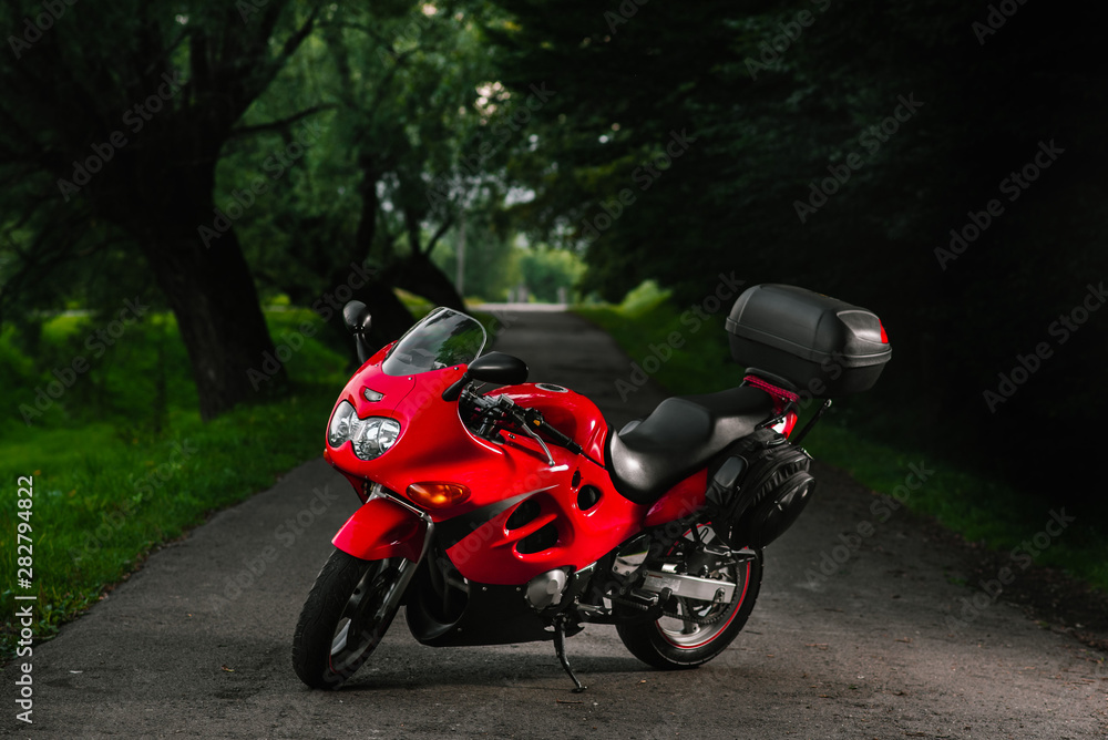 Cool red sports bike outdoors in the evening