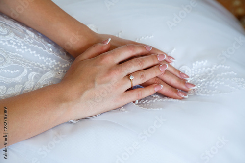 gold wedding rings in hands of newlyweds on wedding day