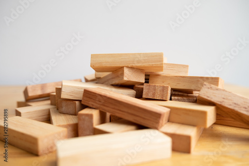 Wood block pile with architecture model  Concept Risk of management and strategy plan  growth business success process and team work