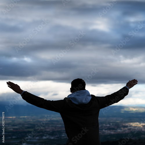 Christian worship and praise. A young man is praying and worshiping in the evening.