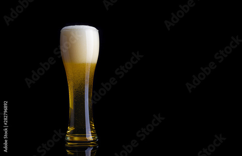 glass of beer on a black background