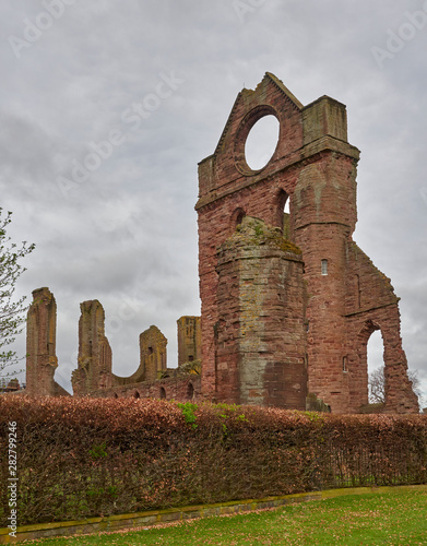 The South Transept of Arbroath Abbey Ruins with its distinctive round Beacon Window, lit up for Mariners at Night. Arbroath, Angus, Scotland. photo