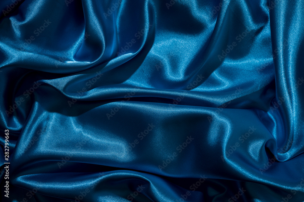 Fototapeta premium Background image of crumpled fabric. Blue silk