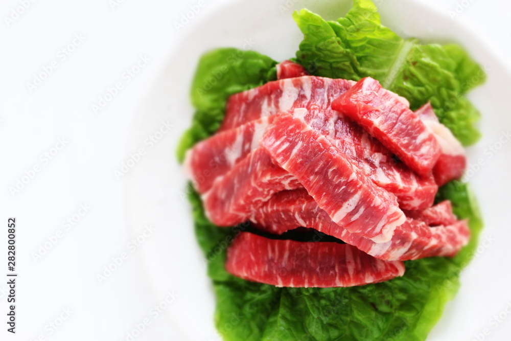 cut beef on lettuce for cooking image