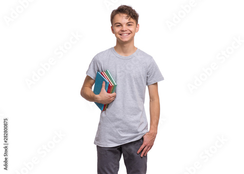 Student teen boy in grey t-shirt holding books and looking at camera. Portrait of cute smiling schoolboy with notebooks, isolated on white background. Happy child Back to school.