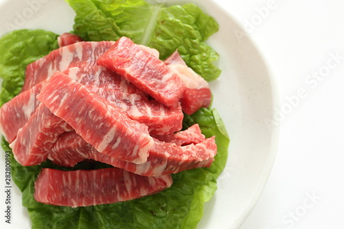 cut beef on lettuce for cooking image