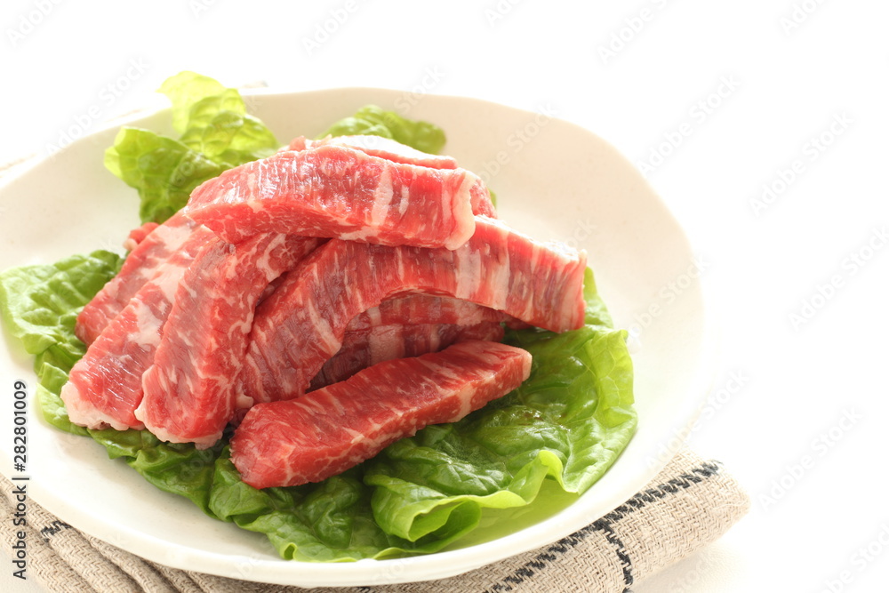 cut beef on lettuce for cooking image