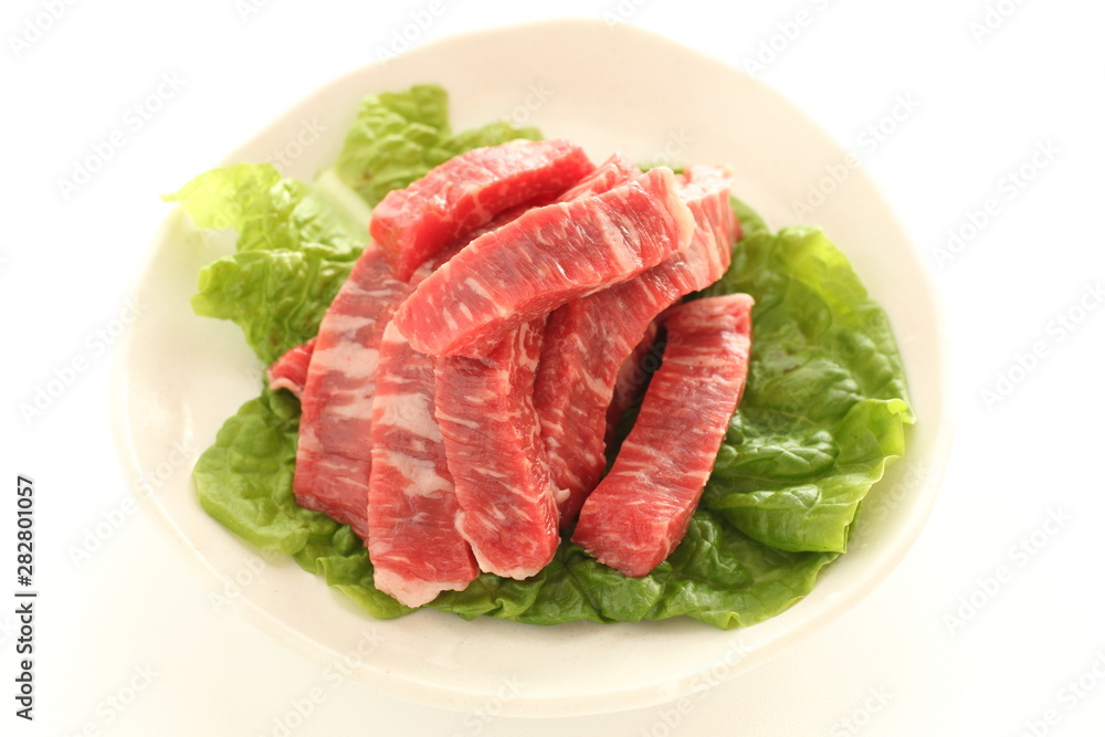 cut beef on lettuce for cooking image