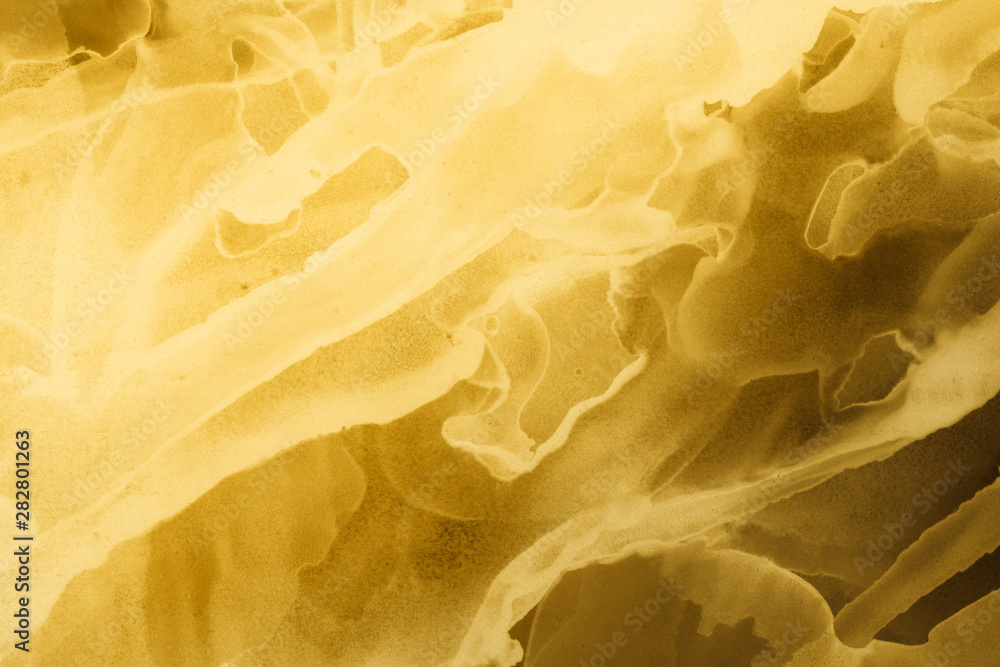 Hand painted gold alcohol ink background. Abstract delicate yellow texture. Contemporary wallpaper. Hand painted gold alcohol ink background. Abstract delicate yellow texture. Contemporary wallpaper.
