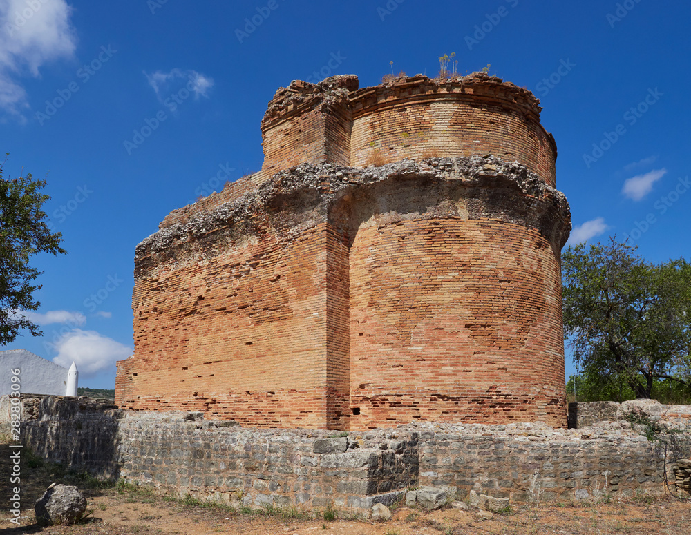 The curving end wall of the water Temple ruins at the ancient Roman Villa of Milreu in the town of Estoi in the Portuguese Algarve.