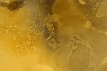 Hand painted gold alcohol ink background. Abstract delicate yellow texture. Contemporary wallpaper. 