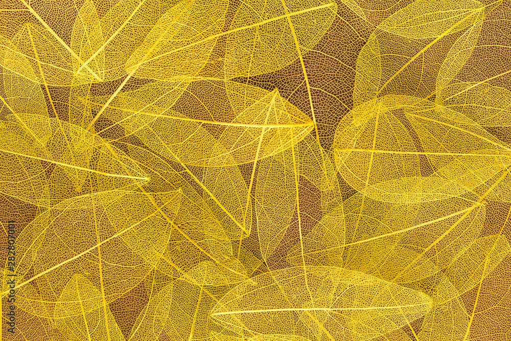 Obraz premium Background from artificial autumn yellow leaves. Nature backdrop.
