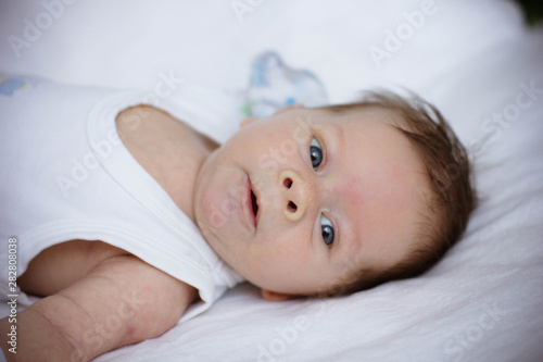 portrait of a baby lying on bed