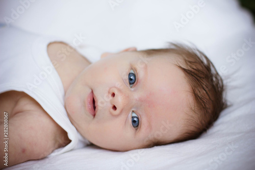 portrait of a baby lying on bed