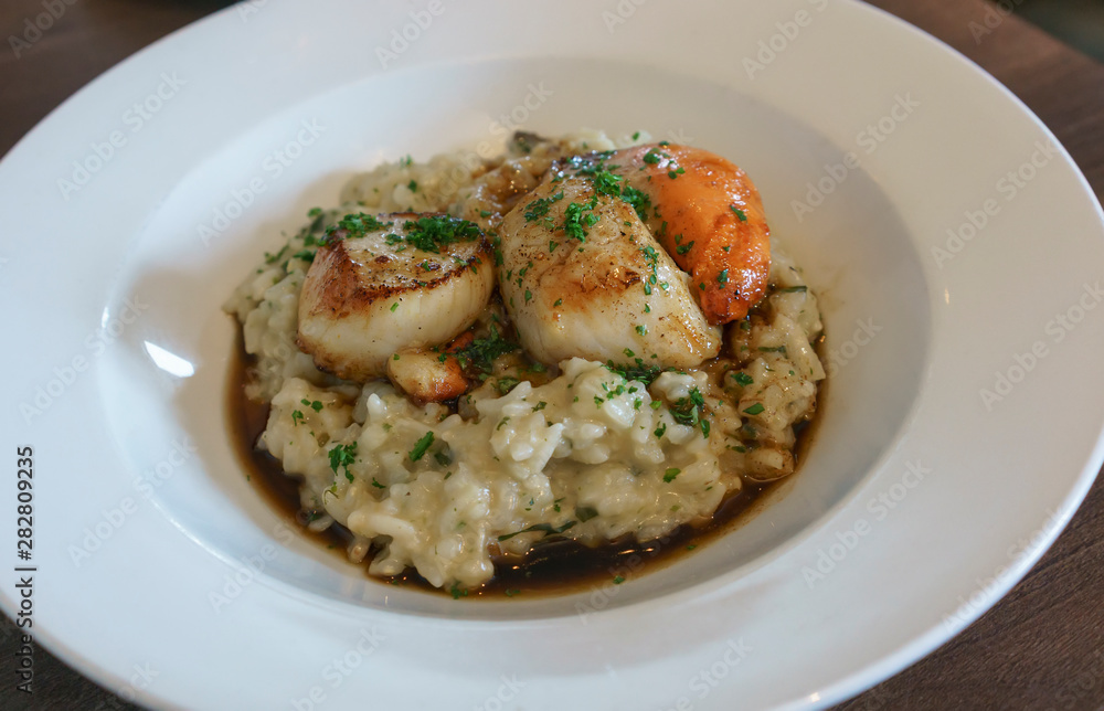 Delicious homemade grilled giant scallops with rice in Portree , Isle of Skye , Scotland Delicious homemade grilled giant scallops with rice in Portree , Isle of Skye , Scotland