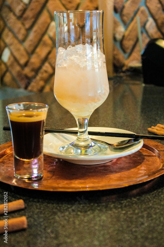 A drink consisting of Baileys liqueur and a drink of mineral water, sweet syrup with ice and a straw. European recipe