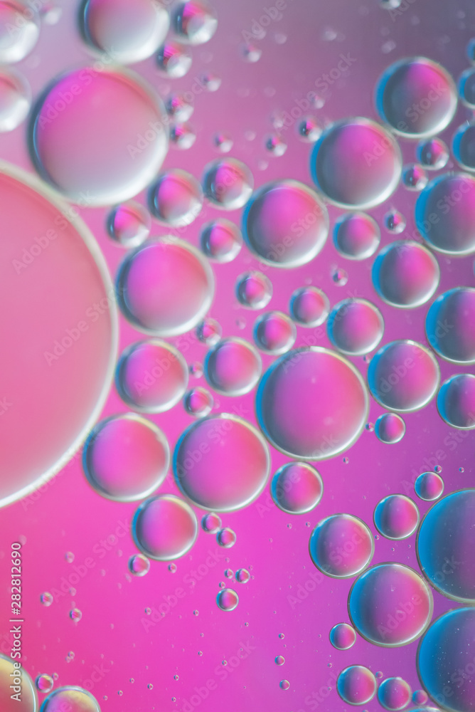 Oil drops in water. Defocused abstract psychedelic pattern image purple colored. Abstract background with colorful gradient colors.