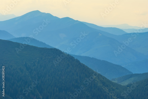 mountain ridge silhouette in a blue mist, natural background