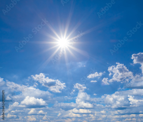 beautiful natural background, blue sky with clouds and sparkle sun