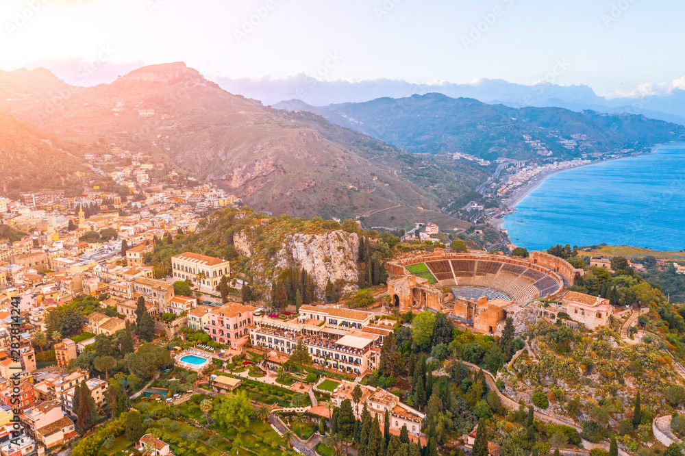 Taormina theater, amphitheater, arena is a town on the island of Sicily, Italy. Aerial view from above in the evening sunset.
