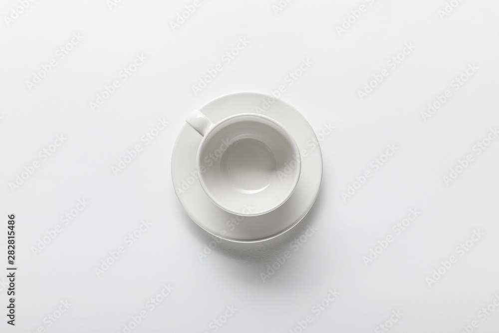 top view of empty white cup on saucer on white background top view of empty white cup on saucer on white background