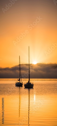 Sunrise over sailboats  © Paul
