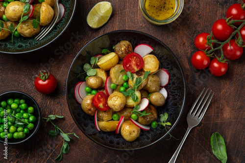 baby potatoes salad with tomato, green peas and radish