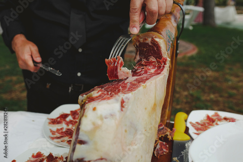 chef slicing spanish ham