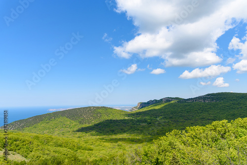 view of the Black Sea from the height of Mount Ayia  a cape on the southern coast of the Crimea  to the south-east of Balaclava. Sunny bright day with clouds on the sky. Spring view of the Crimea.