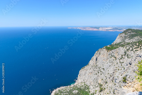 view of the Black Sea from the height of Mount Ayia, a cape on the southern coast of the Crimea, to the south-east of Balaclava. Sunny bright day with clouds on the sky. Spring view of the Crimea.