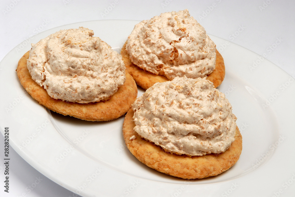 Tasty cookies with meringue on plate on gray background Tasty cookies with meringue on plate on gray background