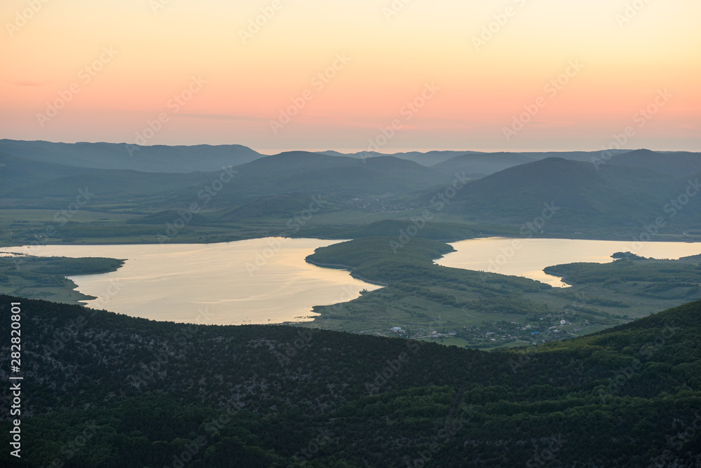 the view of two lakes from the height of the mountain, in the light of the setting sun, the clear cloudless sun. Spring view of the Crimea.