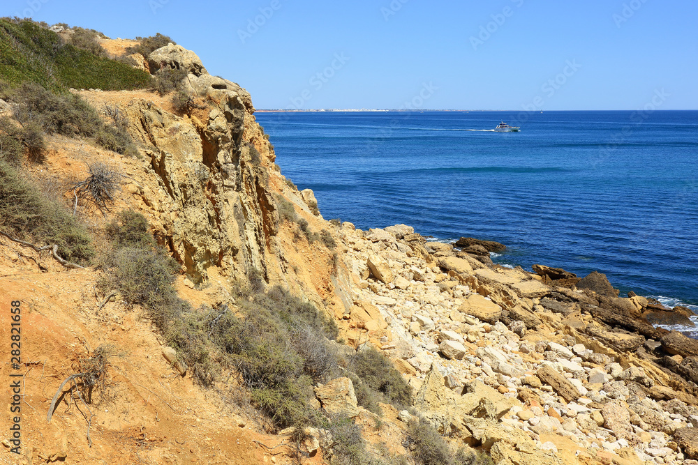 The Atlantic ocean viewed from the rocky beach at Praia Do Arrifao The Atlantic ocean viewed from the rocky beach at Praia Do Arrifao