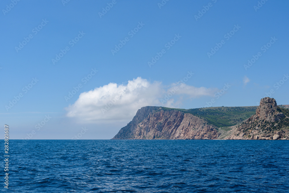 the endless expanses of the black sea, rich blue, on a bright sunny day with clouds in the sky, from the side of a pleasure boat in the black sea. the endless expanses of the black sea, rich blue, on a bright sunny day with clouds in the sky, from the side of a pleasure boat in the black sea.