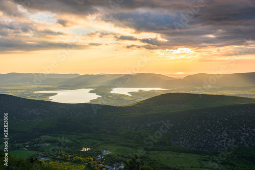 the view of two lakes from the height of the mountain, in the light of the setting sun, the clear cloudless sun. Spring view of the Crimea.