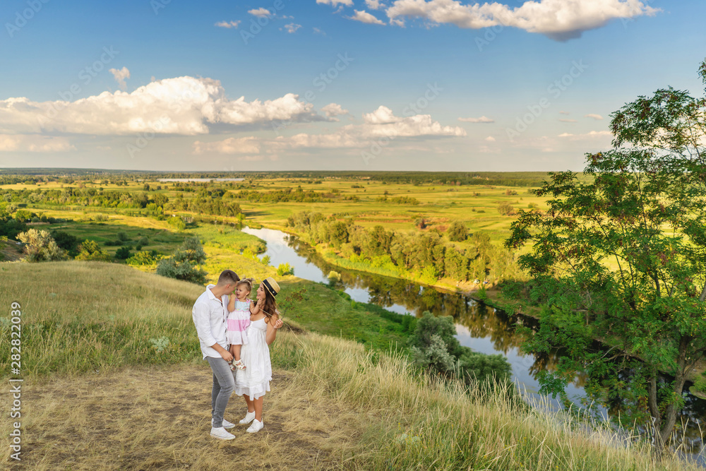 Happy family enjoying life together at meadow outdoor.