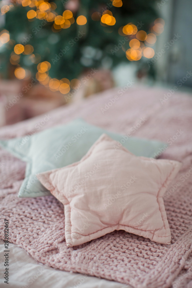 bed with pink and gray bedding and star shaped pillows