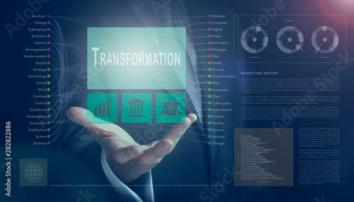 Fotografija Businessman outreached hand holding a Transformation business concept on a computerised screen display