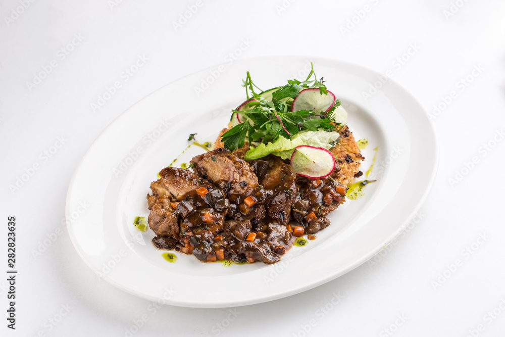 Plate with braised meat and forest mushrooms isolated on white background Plate with braised meat and forest mushrooms isolated on white background