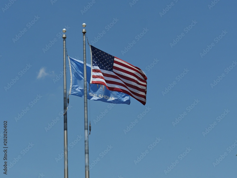Wide shot of the flags of the United States of America and Oklahoma State Wide shot of the flags of the United States of America and Oklahoma State