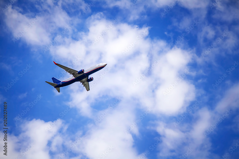 Passenger commercial plane in flight. The aircraft flies airplane a background of clouds. Aircraft side view. - Image