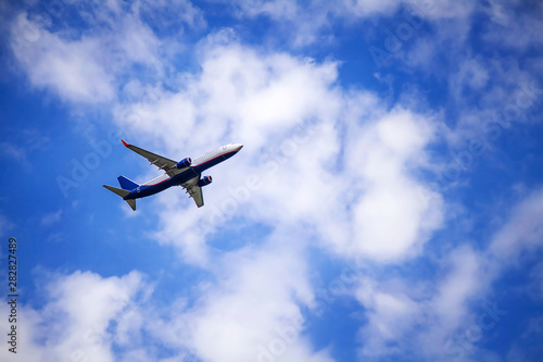 Passenger commercial plane in flight. The aircraft flies airplane a background of clouds. Aircraft side view. - Image